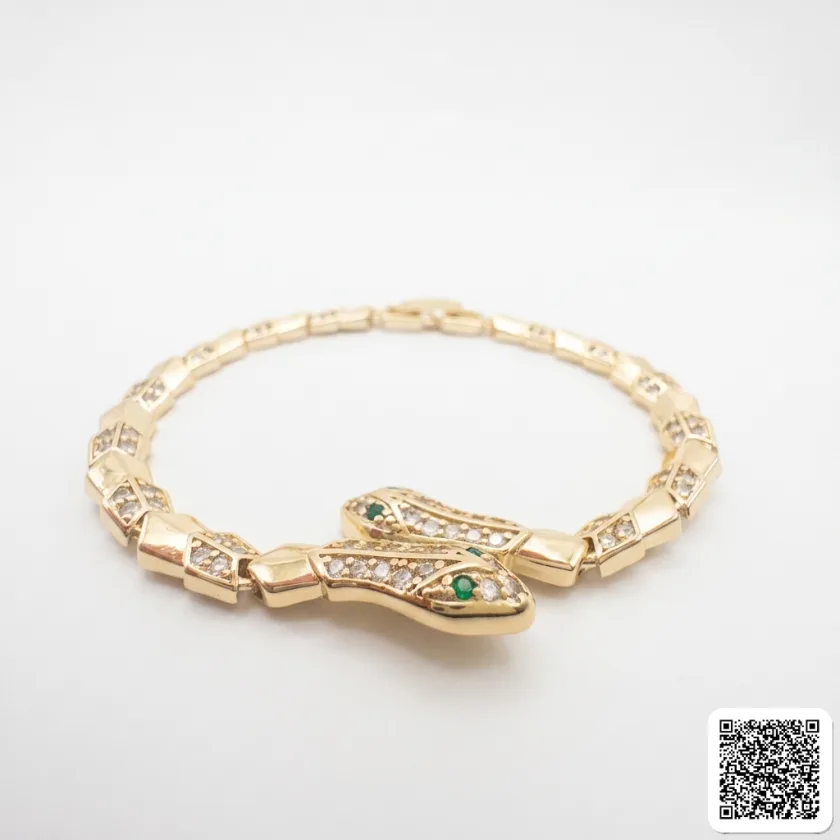 Elegantes Goldfarbenes Armband Mit Strass Und Grünem Stein